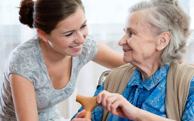 Volunteer helping older woman